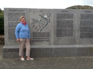 Cathy from Heritage tours Wexford in front of the Memorial wall at Vinegar Hill, Enniscorthy.